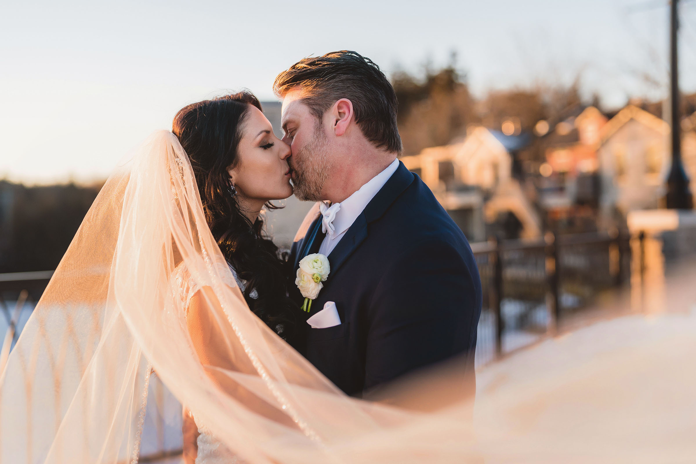 A bride and Groom kissing during Golden Hour